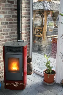 a fireplace sitting on a patio in front of a window at B&B AntiQua & Qook in Tongeren