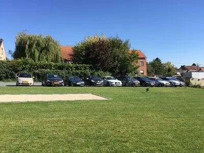 a group of cars parked in a parking lot at B&B AntiQua & Qook in Tongeren