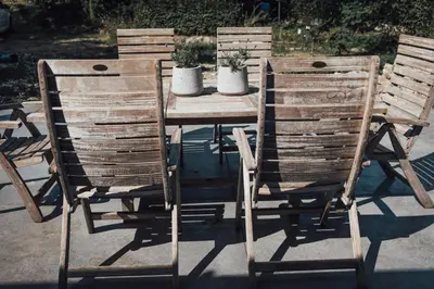 two wooden chairs and a wooden table with plants on it at Loft 88 in Eupen