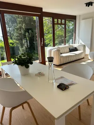 a living room with a white table and chairs at Le Chalet du Pays de Herve in Herve