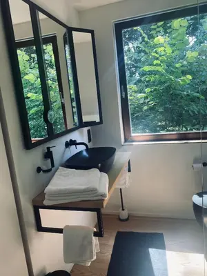 a bathroom with a sink and two windows at Le Chalet du Pays de Herve in Herve