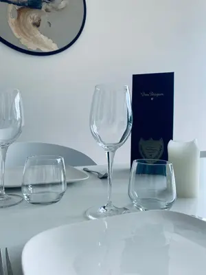 three empty wine glasses sitting on a table at Le Chalet du Pays de Herve in Herve