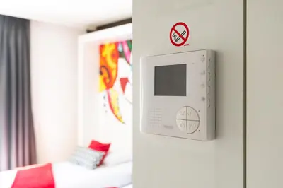 a room with a door with a no smoking sign at Appart'hotel Urban Lodge in Chaudfontaine