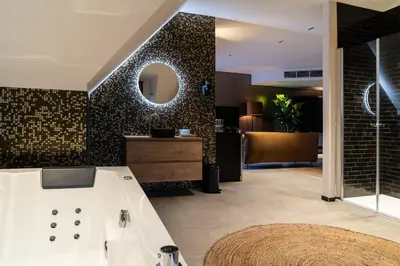 a bathroom with a sink and a mirror on a wall at Hotel de Boskar Houthalen in Houthalen-Helchteren