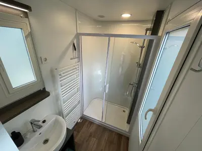 a bathroom with a shower and a sink at Chalet Het Edelhert in Zutendaal