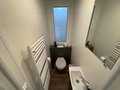 a small bathroom with a toilet and a sink at Chalet Het Edelhert in Zutendaal