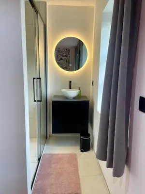 a bathroom with a sink and a mirror at Gite Pays de Herve - Emeraude in Battice