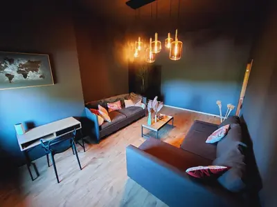 a living room with a couch and a piano at Gite Pays de Herve - Emeraude in Battice