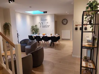 a dining room with a table and chairs in a room at Viator Holidayhome in Tongeren