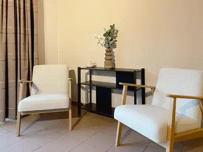two chairs and a table with a vase of flowers on it at 8P 4B Beautiful Villa with swimming pool in Zonhoven in Genk