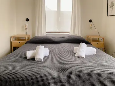 a bedroom with a bed with towels on it at 8P 4B Beautiful Villa with swimming pool in Zonhoven in Genk
