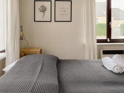 a bedroom with a bed with two pillows and a window at 8P 4B Beautiful Villa with swimming pool in Zonhoven in Genk