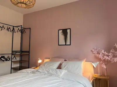 a bedroom with a large bed with white sheets at Boldermountain Guesthouse in Heusden - Zolder