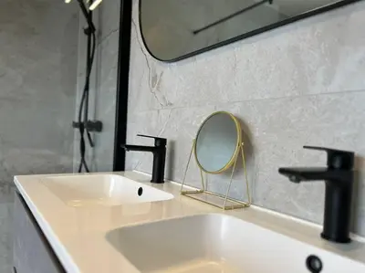 a bathroom with a white sink and a mirror at Boldermountain Guesthouse in Heusden - Zolder