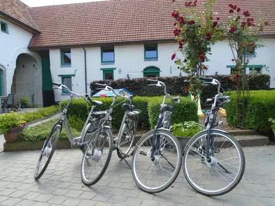 three bikes parked in front of a house at B&B De Oude Winning in Riemst