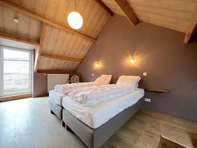 a bedroom with two beds in a attic at Achter de Hegge in Riemst
