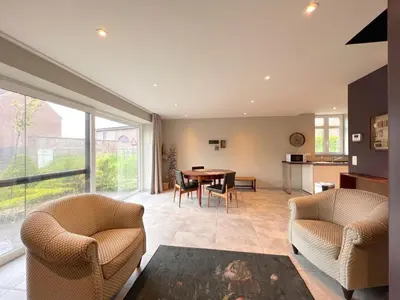 a living room with a table and chairs at Achter de Hegge in Riemst