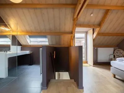 a kitchen and living room with a large black refrigerator at t Bakhuys in Riemst