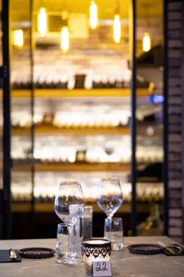 two wine glasses sitting on top of a table at Hôtel de la Tour in Melen