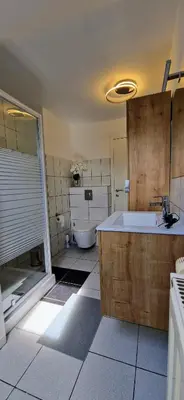 a bathroom with a tub and a sink and a toilet at Trudo Loft in Sint-Truiden