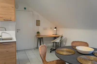 a kitchen and dining room with a table and chairs at Trudo Loft in Sint-Truiden