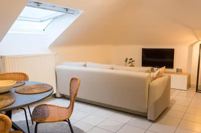 a living room with a couch and a table at Trudo Loft in Sint-Truiden