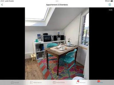 a small kitchen with a table and two chairs at Au 81 in Liège