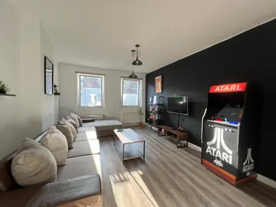 a living room with a couch and a video game at Appartement Verviers in Verviers