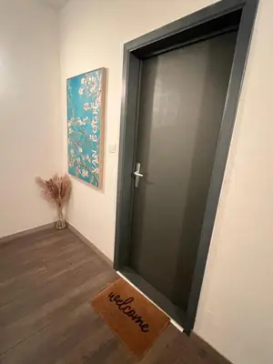 a door with a welcome mat in front of a room at Appartement Verviers in Verviers