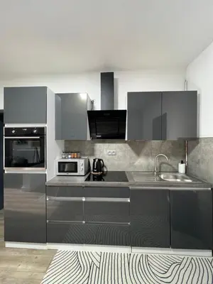 a kitchen with stainless steel cabinets and a sink at Appartement Verviers in Verviers
