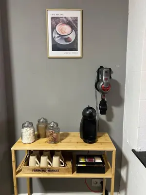 a small wooden table with a coffee maker on it at Appartement Verviers in Verviers