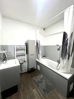 a bathroom with a bath tub and a sink at Appartement Verviers in Verviers