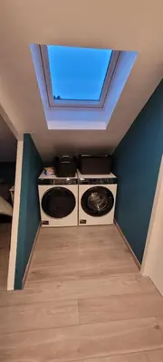 a washer and dryer in a room with a window at Gîte de Trasenster in Trooz