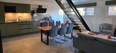 a kitchen and dining room with a table and chairs at Gîte de Trasenster in Trooz