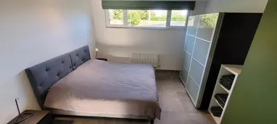 a small bedroom with a bed with a window at Gîte de Trasenster in Trooz