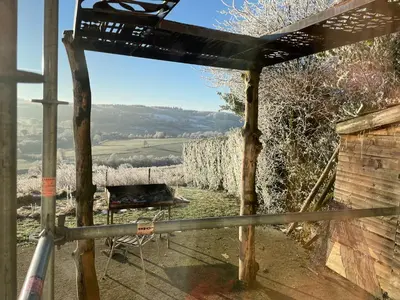 a view from the porch of a house with a chair at À la Belle Vue in Limbourg