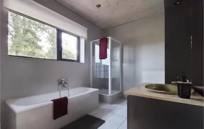 a bathroom with a bath tub and a sink at Pet Friendly Home In As With Wifi in As