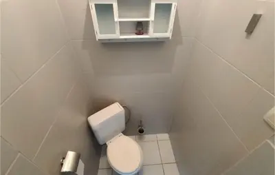 a small bathroom with a toilet and a cabinet at Pet Friendly Home In As With Wifi in As