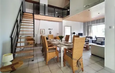 a dining room and living room with a table and chairs at Pet Friendly Home In As With Wifi in As