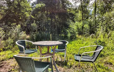 a table and four chairs and a table and chairsitures at Pet Friendly Home In As With Wifi in As