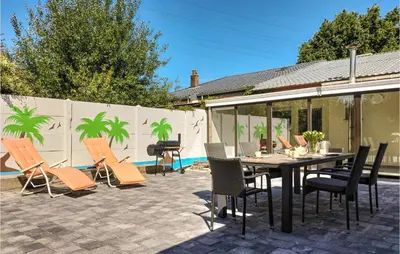 a patio with a table and chairs and a grill at Pet Friendly Home In As With Wifi in As