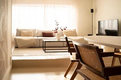 a living room with a couch and a table at Maas Suites - The River House with private sauna in Lanaken