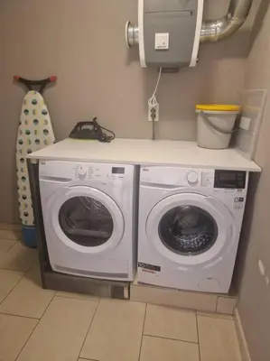 a washing machine and a dryer in a room at Tuinappartement van 175m² en 4 slaapkamers in Hasselt