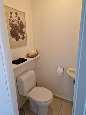 a bathroom with a white toilet and a sink at Tuinappartement van 175m² en 4 slaapkamers in Hasselt