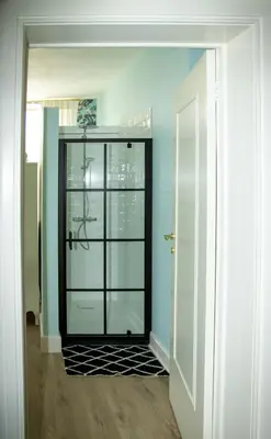 a hallway with a glass door in a room at B&B Huis Spaas in Pelt