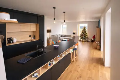 a kitchen with a black counter top and a living room at Spa-Francorchamps - Jahlay - Maison 6p de caractère - Famille - Ardennes - Nature in Jalhay