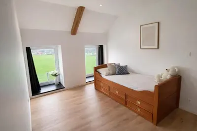 a bedroom with a bed and two windows at Spa-Francorchamps - Jahlay - Maison 6p de caractère - Famille - Ardennes - Nature in Jalhay