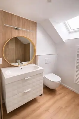 a bathroom with a sink and a toilet and a skylight at Spa-Francorchamps - Jahlay - Maison 6p de caractère - Famille - Ardennes - Nature in Jalhay