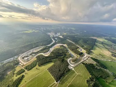 an aerial view of a winding road in a field at Spa-Francorchamps - Jahlay - Maison 6p de caractère - Famille - Ardennes - Nature in Jalhay