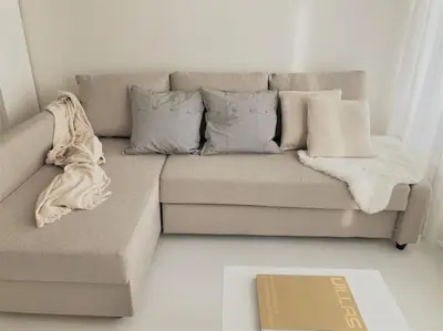 a couch with pillows and a blanket on it at COCONUT MILK in Liège